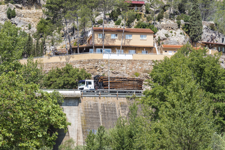 Truck carrying tree trunks through a bridge in Spainの写真素材