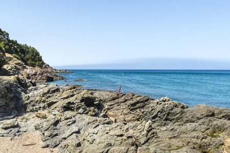 Girona, Spain - July 1, 2015: Boy on a cliff on the Costa Brava, Catalonia, Spainのeditorial素材