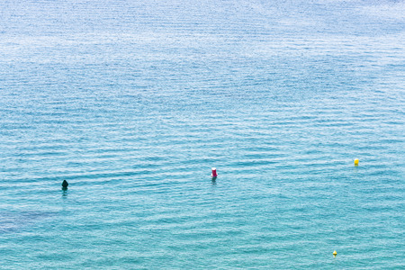 Colored four buoys floating in the sea in Costa Brava, Catalonia, Spainの写真素材