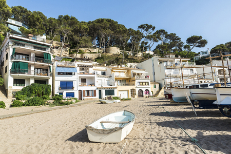 Typical fishing boats on the beach of Sa Riera in the Costa Brava, Catalonia, Spain.の写真素材