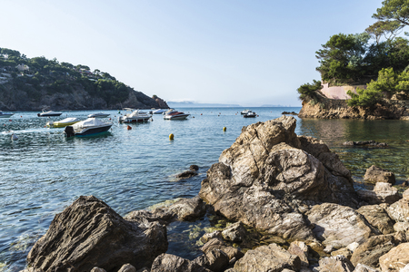 Boats moored on the beach of Sa Riera in the Costa Brava, Catalonia, Spain.の写真素材