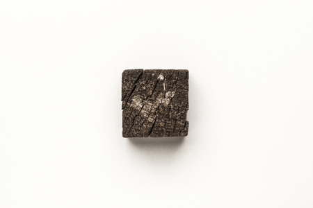 Close-up of old wooden cube isolated on white backgroundの写真素材
