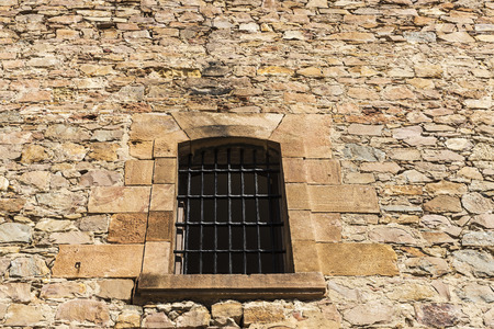 Old stone wall with a latticed window as backgroundの写真素材