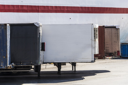 Containers parked in a row waiting to board at the port of Barcelona, Catalonia, Spain
