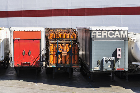 Barcelona, Spain - April 19, 2016: Containers parked in a row waiting to board at the port of Barcelona, Catalonia, Spainのeditorial素材