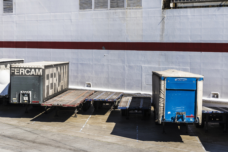 Barcelona, Spain - April 19, 2016: Containers parked in a row waiting to board at the port of Barcelona, Catalonia, Spainのeditorial素材