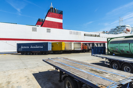Barcelona, Spain - April 19, 2016: White cargo ship moored in the port of Barcelona with containers parked ready for shipping in Barcelona, Catalonia, Spainのeditorial素材