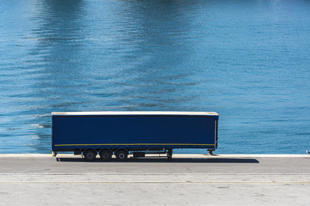 Blue container parked in a row waiting to board at the port of Barcelona, Catalonia, Spainの写真素材