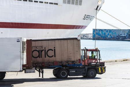 Barcelona, Spain - April 19, 2016: Truck moving a container to load it on a cargo ship at the port of Barcelona, Catalonia, Spainのeditorial素材