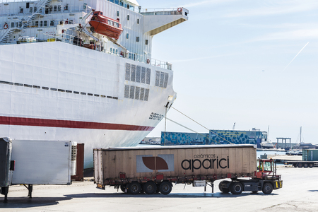 Barcelona, Spain - April 19, 2016: Truck moving a container to load it on a cargo ship at the port of Barcelona, Catalonia, Spainのeditorial素材