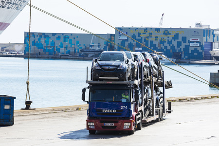 Barcelona, Spain - April 19, 2016: Iveco truck brand carrying new cars at the port of Barcelona, Catalonia, Spainのeditorial素材