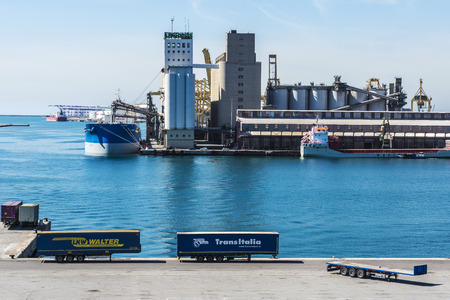 Barcelona, Spain - April 19, 2016: Containers parked in a row waiting to board at the port of Barcelona, Catalonia, Spainのeditorial素材