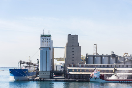 Barcelona, Spain - April 19, 2016: Ship being loaded of grain from a silo in the port of Barcelona, Catalonia, Spainのeditorial素材