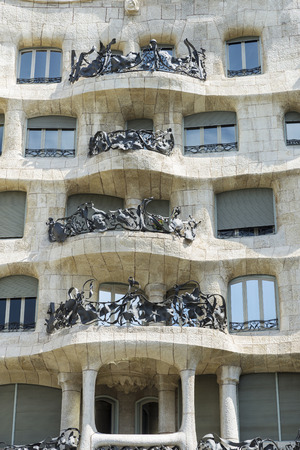 Barcelona, Spain - May 25, 2016: View of Casa Mila, better known as La Pedrera, designed by Antoni Gaudi, and a modernist style streetlight on the Passeig de Gracia, Barcelona, Catalonia, Spain.のeditorial素材
