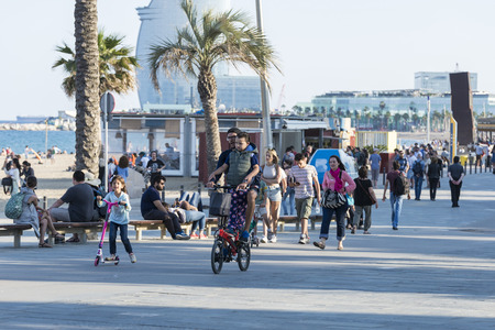 Barcelona, Spain - June 1, 2016: Barcelona promenade full of people walking or playing sportsのeditorial素材