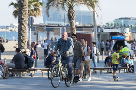 Barcelona, Spain - June 1, 2016: Barcelona promenade full of people walking or playing sportsのeditorial素材