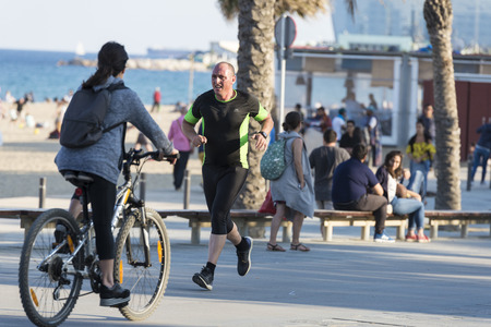 Barcelona, Spain - June 1, 2016: Barcelona promenade full of people walking or playing sportsのeditorial素材