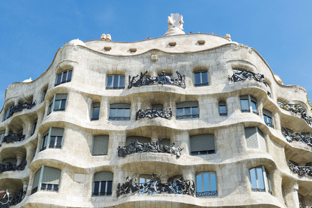 Barcelona, Spain - May 25, 2016: View of Casa Mila, better known as La Pedrera, designed by Antoni Gaudi, and a modernist style streetlight on the Passeig de Gracia, Barcelona, Catalonia, Spain.のeditorial素材