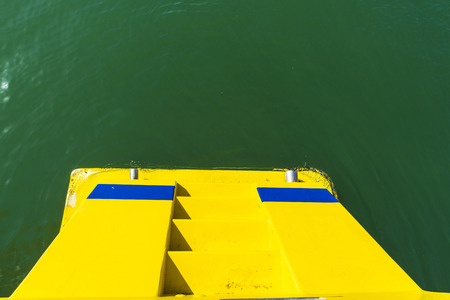 Yellow stern with stairs of a boatの写真素材