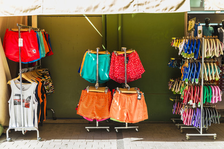 Estartit, Spain - June 24, 2016: Objects of all kinds in a souvenir shop highlighting swimsuit and flip flops in the Costa Brava, Catalonia, Spainのeditorial素材