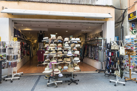 Estartit, Spain - June 24, 2016: Objects of all kinds in a souvenir shop highlighting panama hat in the Costa Brava, Catalonia, Spainのeditorial素材