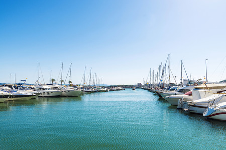 Yachts and sailboats docked at the marina in Estartit located in the Costa Brava, Girona, Catalonia, Spainの写真素材