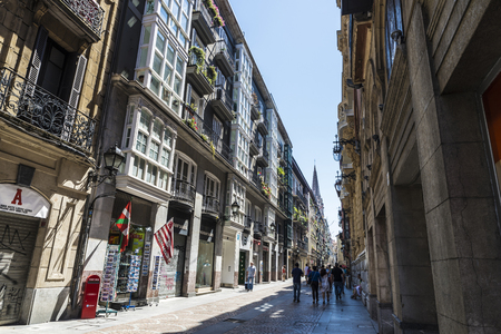 Bilbao, Spain - August 13, 2016: Street of the old town of Bilbao with people walking and a souvenir shopのeditorial素材