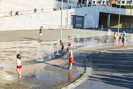 Bilbao, Spain - August 13, 2016: Children bathing in a park with fountains and water jets in the center of Bilbaoのeditorial素材