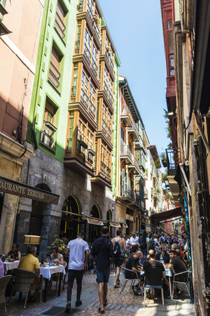 Bilbao, Spain - August 13, 2016: Street of the old town of Bilbao with people having a drink on the terraces of the barsのeditorial素材