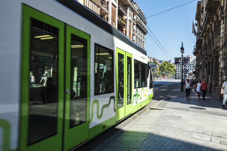 Bilbao, Spain - August 13, 2016: Tram running through the center of Bilbao and people walkingのeditorial素材