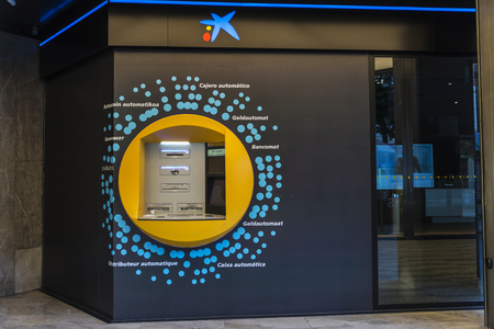Bilbao, Spain - August 13, 2016: ATM Cash Machine of Caixabank in several languages in the old town of Bilbaoのeditorial素材