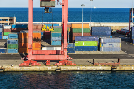 Huge port crane surrounded by containers in Barcelona, Catalonia, Spain