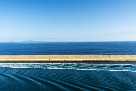 Breakwater built with concrete blocks as background in Sardinia, Spainの写真素材