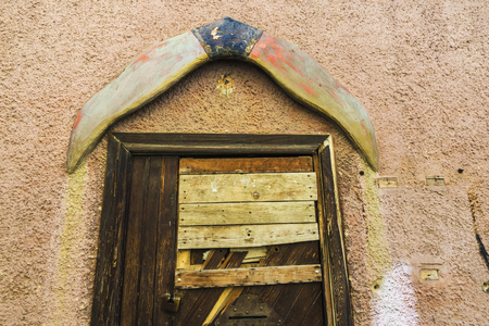 Closeup of an old wooden door as background in Olbia, Sardinia, Italyの写真素材