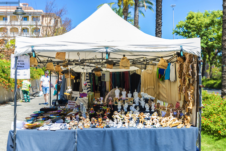 Olbia, Italy - August 24, 2016: Objects of all kinds in a souvenir shop highlighting Catholic religious figures in a flea market in  Olbia, Sardinia, Italyのeditorial素材