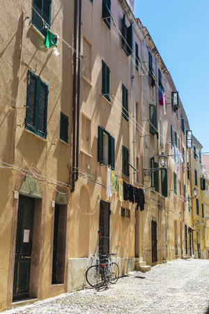 Street of the old town with two bicycles parked in Alghero, Sardinia, Italyの写真素材