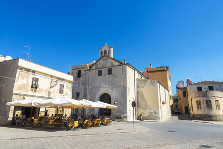 Alghero, Italy - August 26, 2016: Restaurant and bar terraces with people sitting on the street of the old town  in Alghero, Sardinia, Italyのeditorial素材