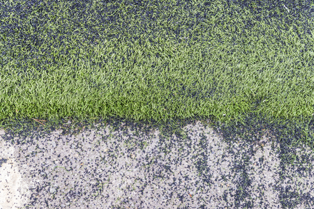 Soccer field made of bits of black synthetic rubber and plastic grassの写真素材