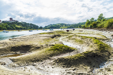 San Vicente de la Barquera estuary or river mouth between meadows and mountains in Cantabria, Spain