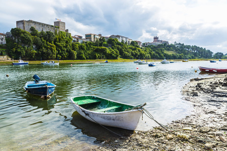 Fishing boats in the village of San Vicente de la Barquera in Cantabria, Spainの写真素材