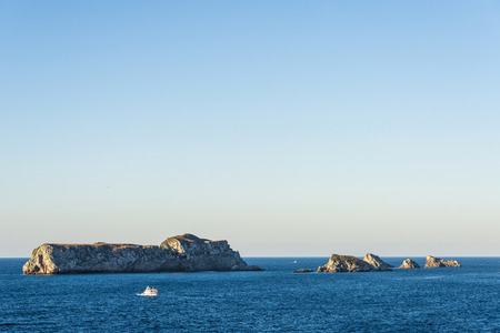 Island with rocky coast of the Atlantic Ocean in Suances, Cantabria, Spainの写真素材