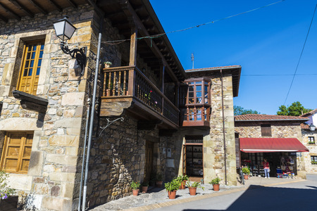 Lierganes, Spain - August 11, 2016: Street with old historic building and people walking in the medieval village of Lierganes in Cantabria, Spainのeditorial素材