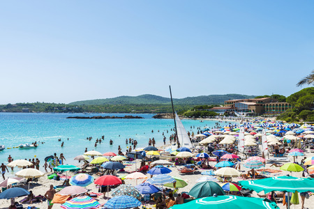 Alghero, Italy - August 22, 2016: Beach full of bathers in summer in Alghero, Sardinia, Italyのeditorial素材
