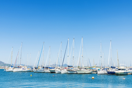Sailboats and yachts docked at the marina in Alghero, Sardinia, Italyの写真素材