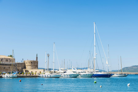 Sailboats and yachts docked at the marina in Alghero, Sardinia, Italyの写真素材