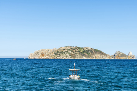 Estartit, Spain - June 24, 2016: Boats and yachts sailing with people with the Medes islands in the background at the Costa Brava, Girona, Catalonia, Spainのeditorial素材