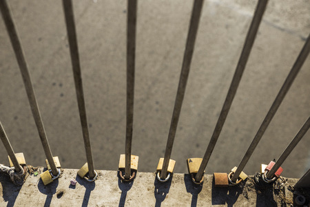 Various padlocks with drawn hearts tied on a bridge in Rome, Italy
