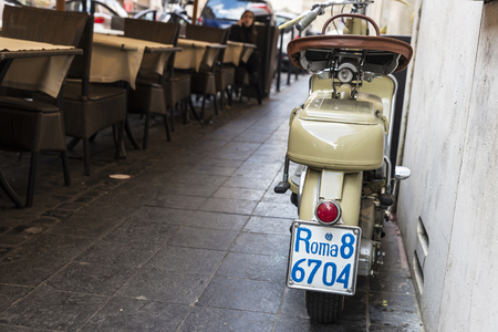 Rome, Italy - January 2, 2017: Classic motorcycle parked on the sidewalk in front of a bar with the license plate of Rome, Italyのeditorial素材