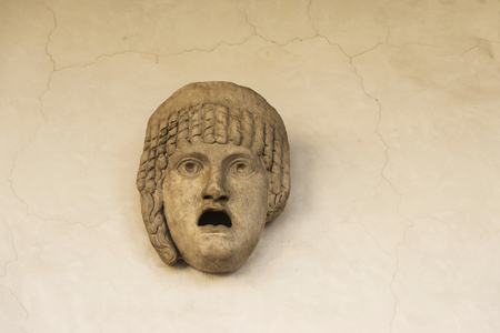 Roman statue of a human face with open mouth in Rome, Italyの写真素材