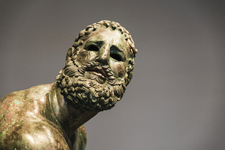 Roman bust or statue made with bronze of a human face called The fighter of the thermal bath or...
